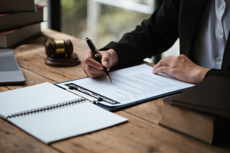 Close up of hand signing documents