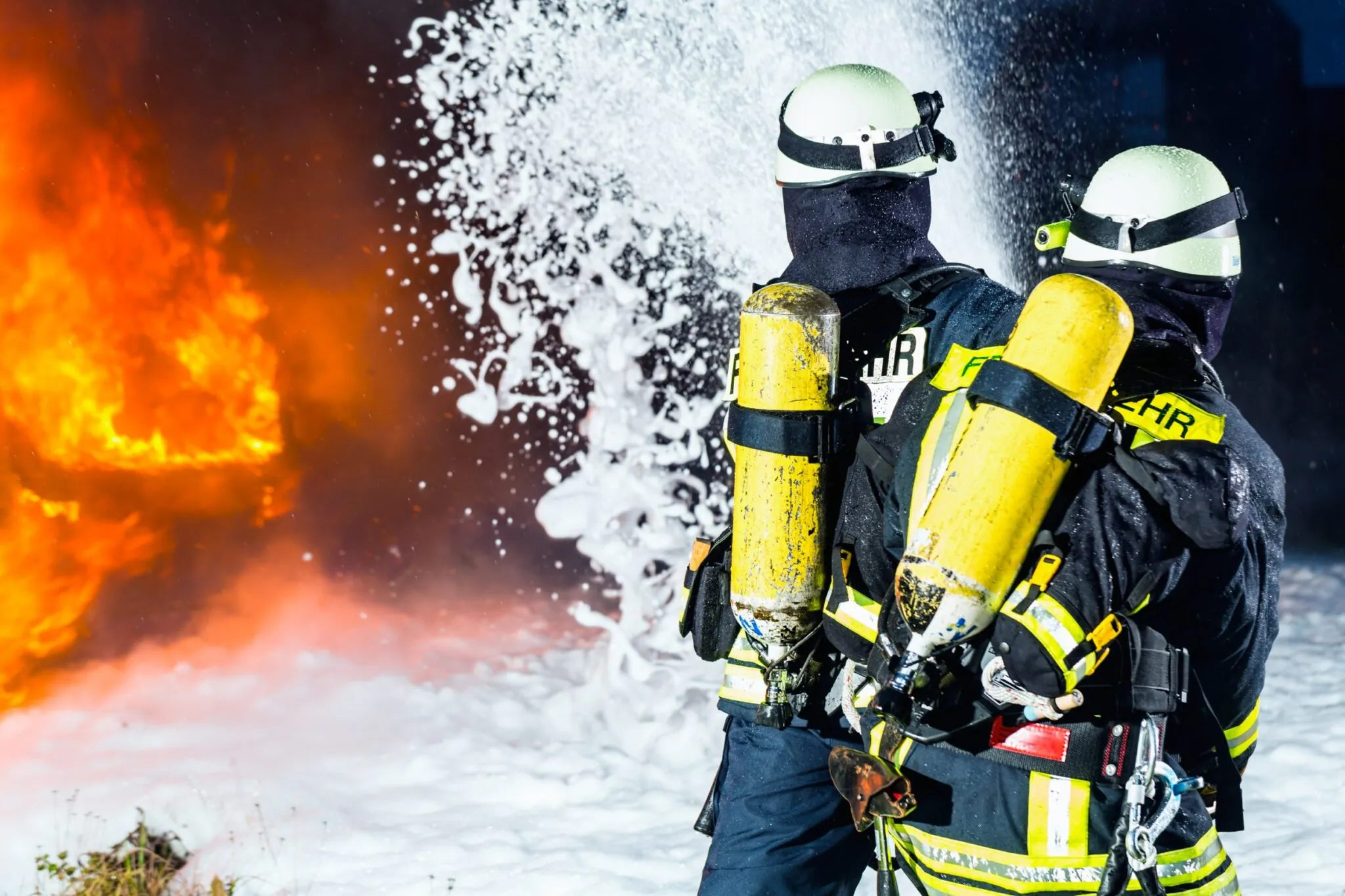 Firefighters extinguishing fire using AFFF