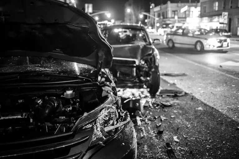 serious multi-car accident on a city street at night