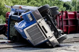 Jackknifed rig on its side on a highway