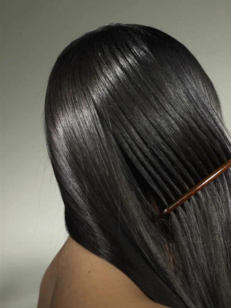 Woman using hair relaxer