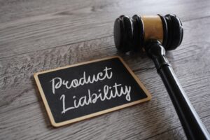 product liability is written in chalk on a small slate with a judge's gavel positioned next to it