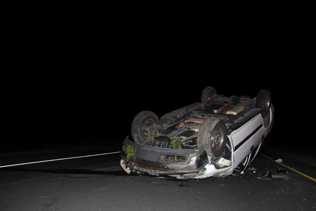 car on its hood at night