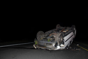 car on its hood at night