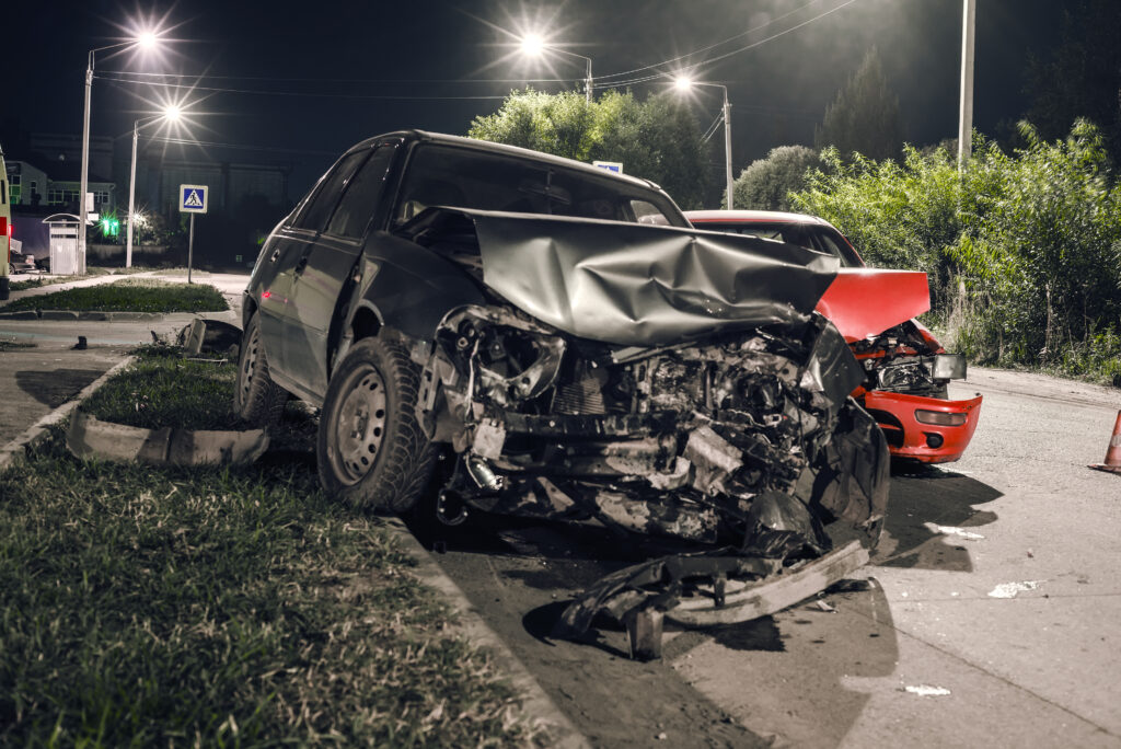 Collision between two cars on an asphalt road at night
