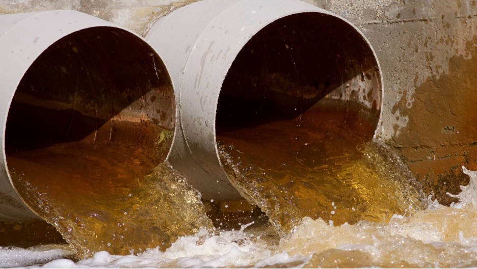 Discolored water being discharged from large outfall pipes