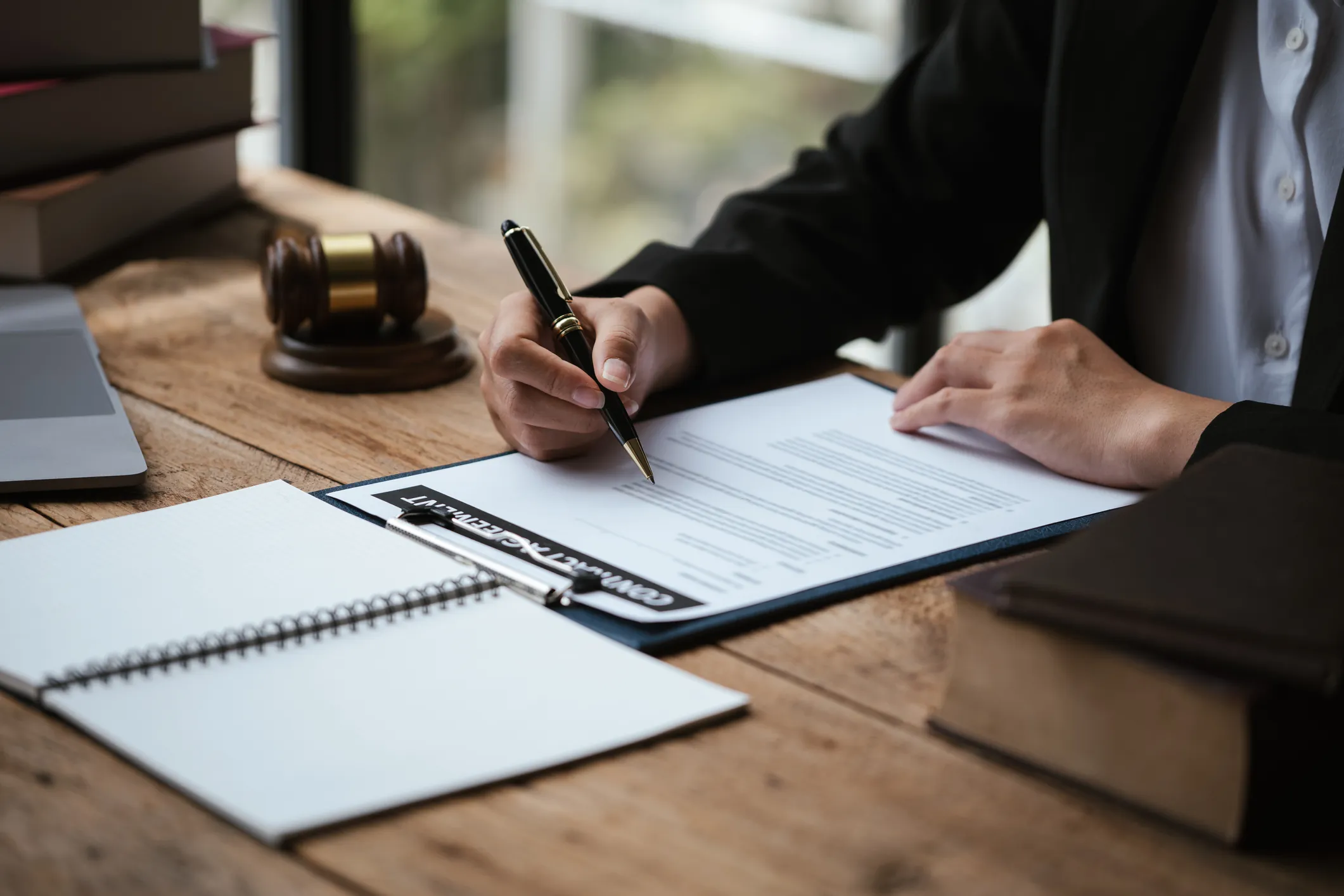 Close up of hand signing documents